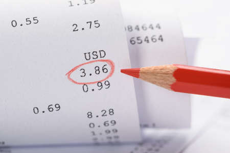 Close-up Of Generic Rolled Up Receipt With Costs And Red Markingの写真素材