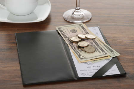 Close-up Of Bill With American Dollars On Wooden Tableの写真素材