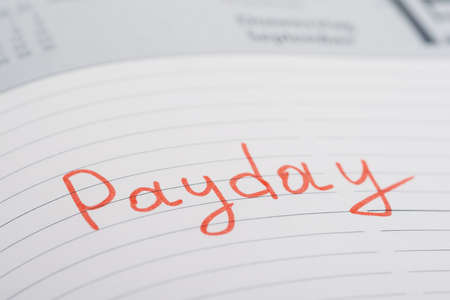 Photo Of Payday Word Written On Diary Bookの写真素材