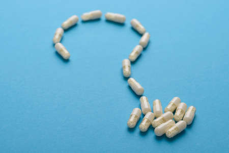 Question Mark Made From Capsules Over Blue Backgroundの写真素材