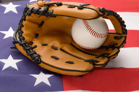 Baseball In An Leather Glove Over American Flagの写真素材