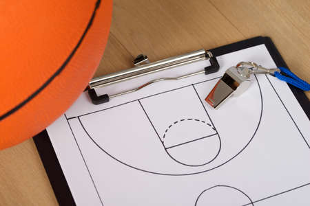 Close-up Of Basketball With Whistle And Sport Tactics On Paperの写真素材