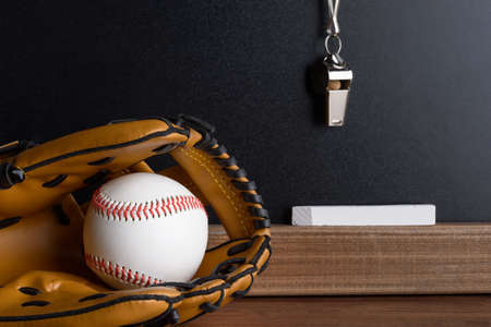Close-up Of Blackboard With Baseball; Sport Whistle; Chalk And Leather Glovesの写真素材