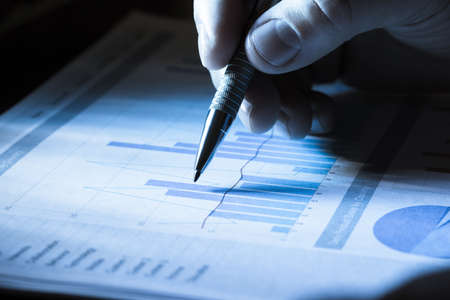 Close-up Of A Hand With A Pen On Graphの写真素材
