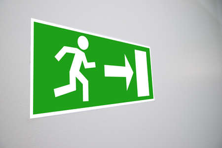 Close-up Of Emergency Evacuation Sign On Wallの写真素材