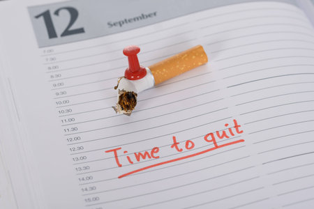 Broken Cigarette On Diary With Pushpin Attachedの写真素材