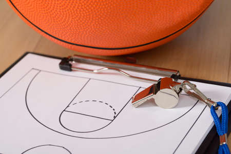 Close-up Of Basketball With Whistle And Sport Tactics On Paperの写真素材