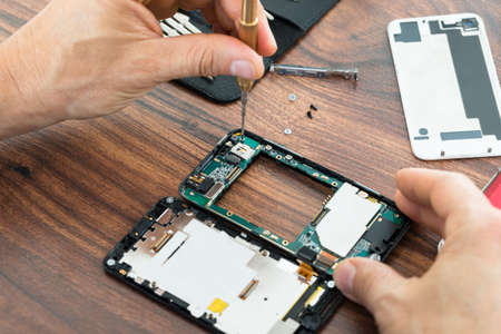 Close-up Photo Of Technician Hand Repairing Cellphone