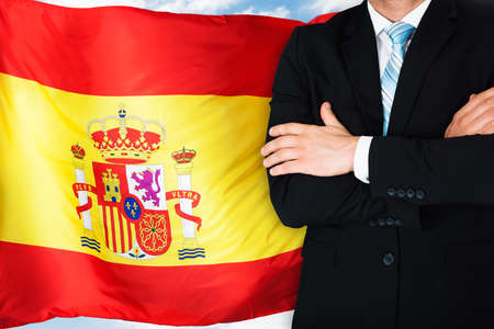Close-up Of Businessman In Front Of Spanish Flagの写真素材