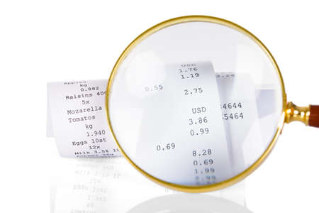 Close-up Of Person Holding Magnifying Glass On Receiptの写真素材
