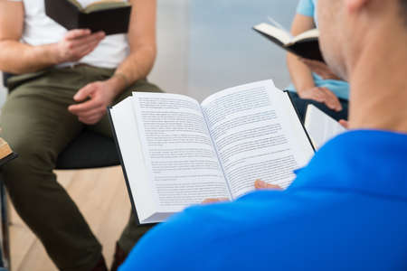 Group Of Multiethnic Friends Reading Bible Together