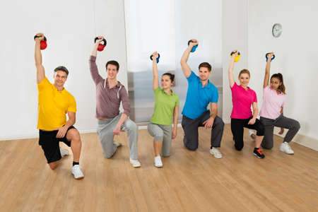 Diverse Multiethnic Group Of People Working Out With Kettle Bell Weights