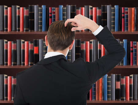 Portrait Of Man In A Suit Scratching His Head In Courtroomの写真素材