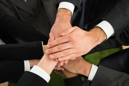 Close-up Of Businesspeople Stacking Hands On Top Of Each Other