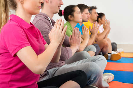 Multiethnic Group Of People Doing Meditation At Gymの写真素材