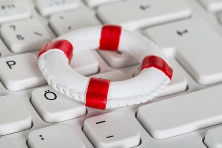 Close-up Of Lifebelt On Computer Keyboardの写真素材