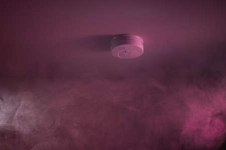 Wispy Smoke Around White Fire Sensor In Houseの写真素材