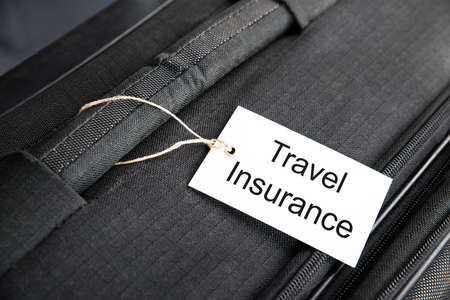 Travel Insurance Label Tied To A Suitcaseの写真素材