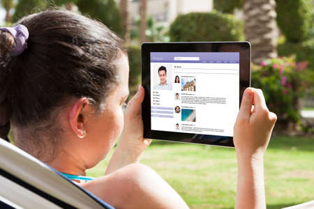 Close-up Of Young Woman Chatting On Social Site With Digital Tablet