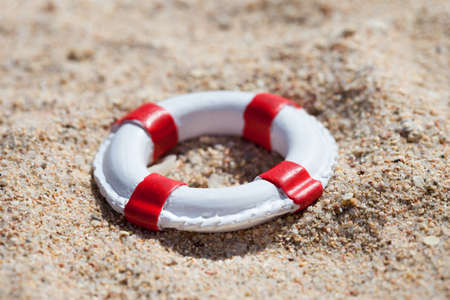 Photo Of Miniature Lifebuoy Lying On Sandの写真素材