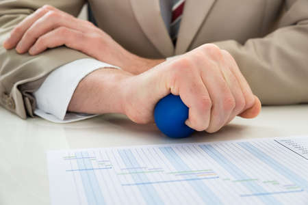 Close-up Of Businessperson Hand Squeezing Stressball In Handの写真素材