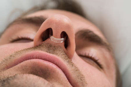 Extreme Close-up Of Man Face With Nose Clip Deviceの写真素材