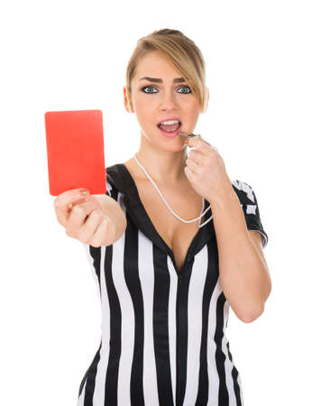 Young Female Referee Holding Red Card Over White Backgroundの写真素材