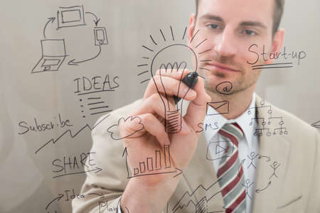 Businessman Writing Start Up Planning With Marker On Glassの写真素材