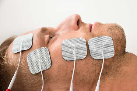 Close-up Of Young Man With Electrodes On Faceの写真素材