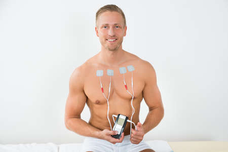 Portrait Young Happy Man With Electrodes On Chestの写真素材