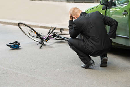 Sad Male Driver After Collision With Bicycle On Roadの写真素材