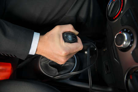 Close-up Of A Hand On Manual Gear Shift Knob While Drivingの写真素材