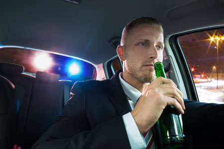 Young Man Drinking Beer And Pulled Over By Policeの写真素材