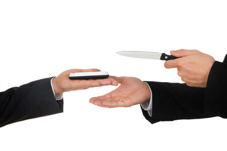 Businessman Hand Showing Knife To The Businessperson With Mobile Phone Over White Background
