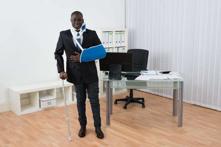 Portrait Of Happy Disabled African Businessman Standing In Officeの写真素材