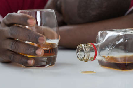 Close-up Of Man's Hand Holding Glass Of Whisky