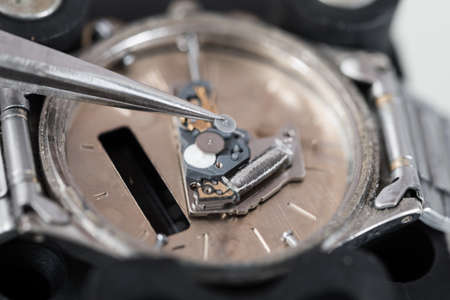 Close-up Photo Of Tweezers Repairing Wrist Watchの写真素材