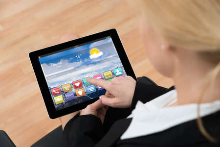 Close-up Of Businesswoman Using Digital Tablet With Multicolored App