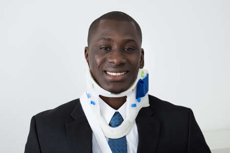 Portrait Of Happy African Businessman With Neck Brace