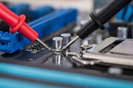 Close-up Photo Of Multimeter And Motherboard Repairの写真素材