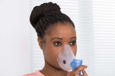 Close-up Of Young African Woman Using Oxygen Mask
