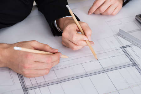 Cropped image of young business people discussing a architectural drawing