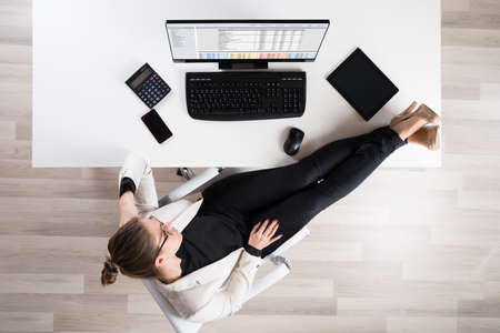 High Angle View Of Tired Businesswoman Relaxing On Chair