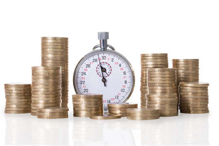 Stopwatch and coin stacks isolated over white background