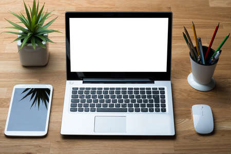 High angle view of technologies with office supply and potted plant on wooden desk