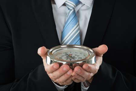 Close-up Photo Of Person Hand Holding Compassの写真素材