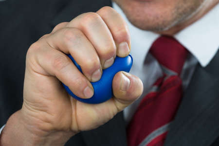 Close-up Of A Businessperson Pressing Stressball In Handの写真素材
