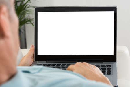 Close-up Of Person Holding Laptop With Blank Screenの写真素材