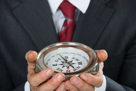 Close-up Photo Of Businessman Hand Holding Compassの写真素材