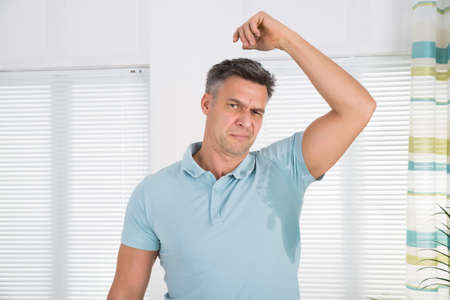 Man With Hyperhidrosis Sweating Very Badly Under Armpit At Homeの写真素材